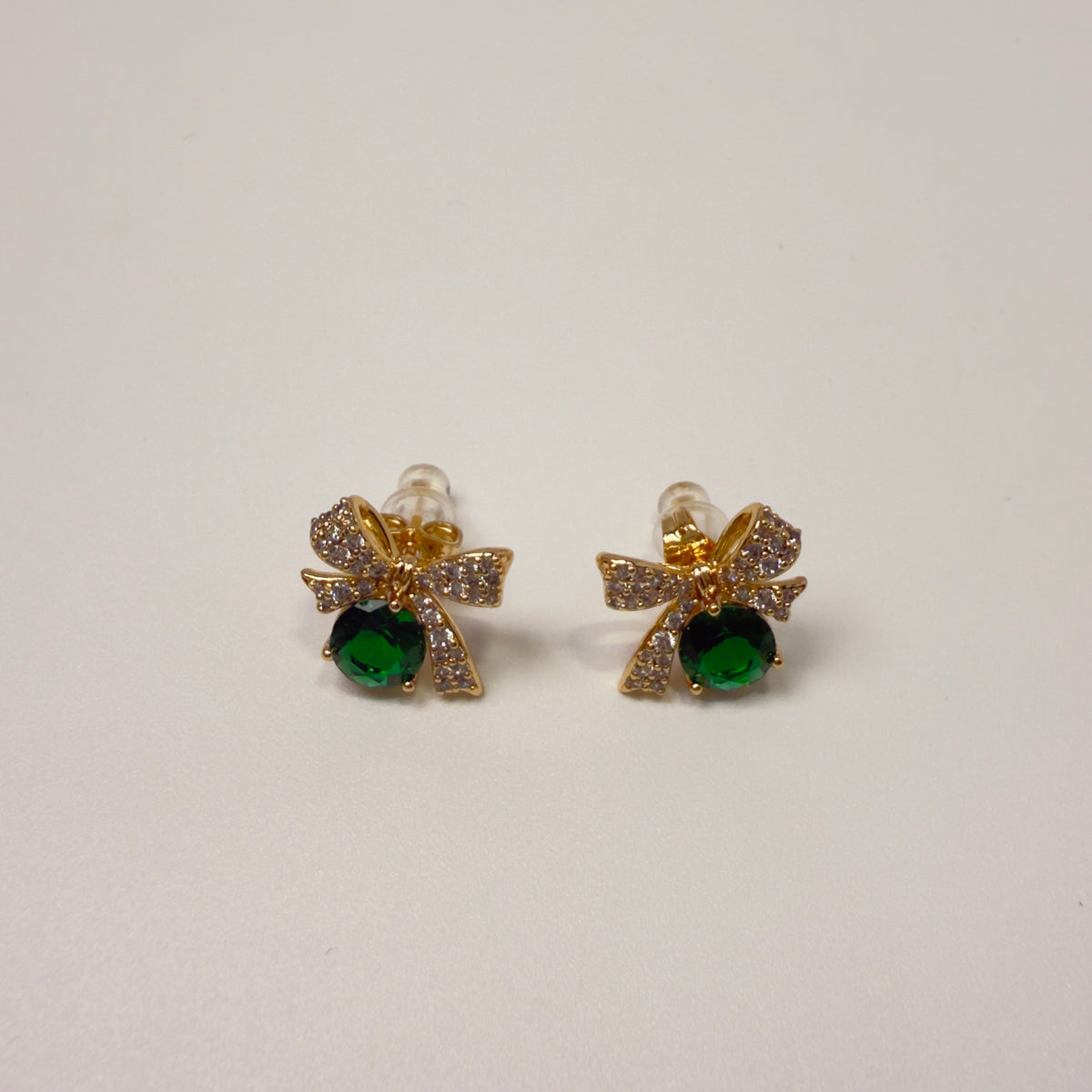 bow-shaped emerald earrings